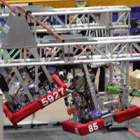 Two robots hang at different elevations at the end of a match